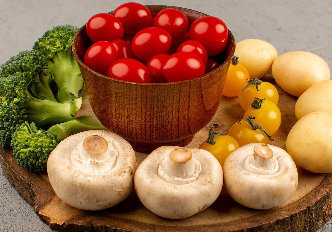 front-view-vegetables-mushrooms-tomatoes-broccoli-potatoes-grey-floor